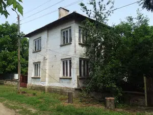 Old country house with barn and land in a village near river